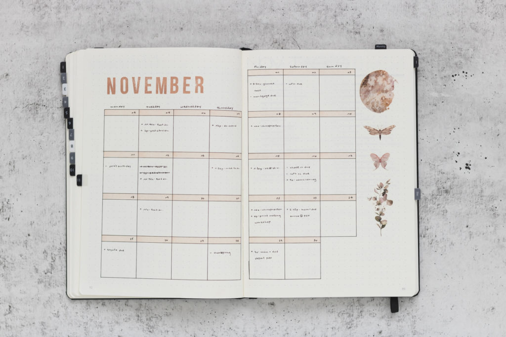 November 2019 monthly Bullet Journal spread featuring moon, moth, and foliage decor